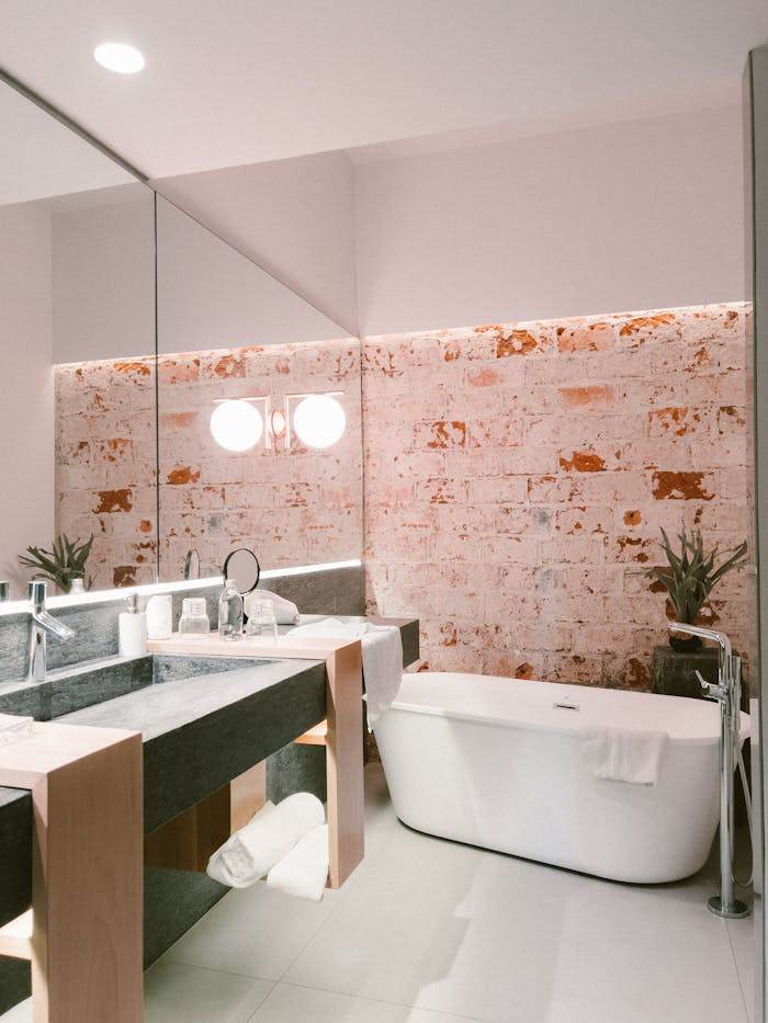 Modern Bathroom with Freestanding Tub and Exposed Brick